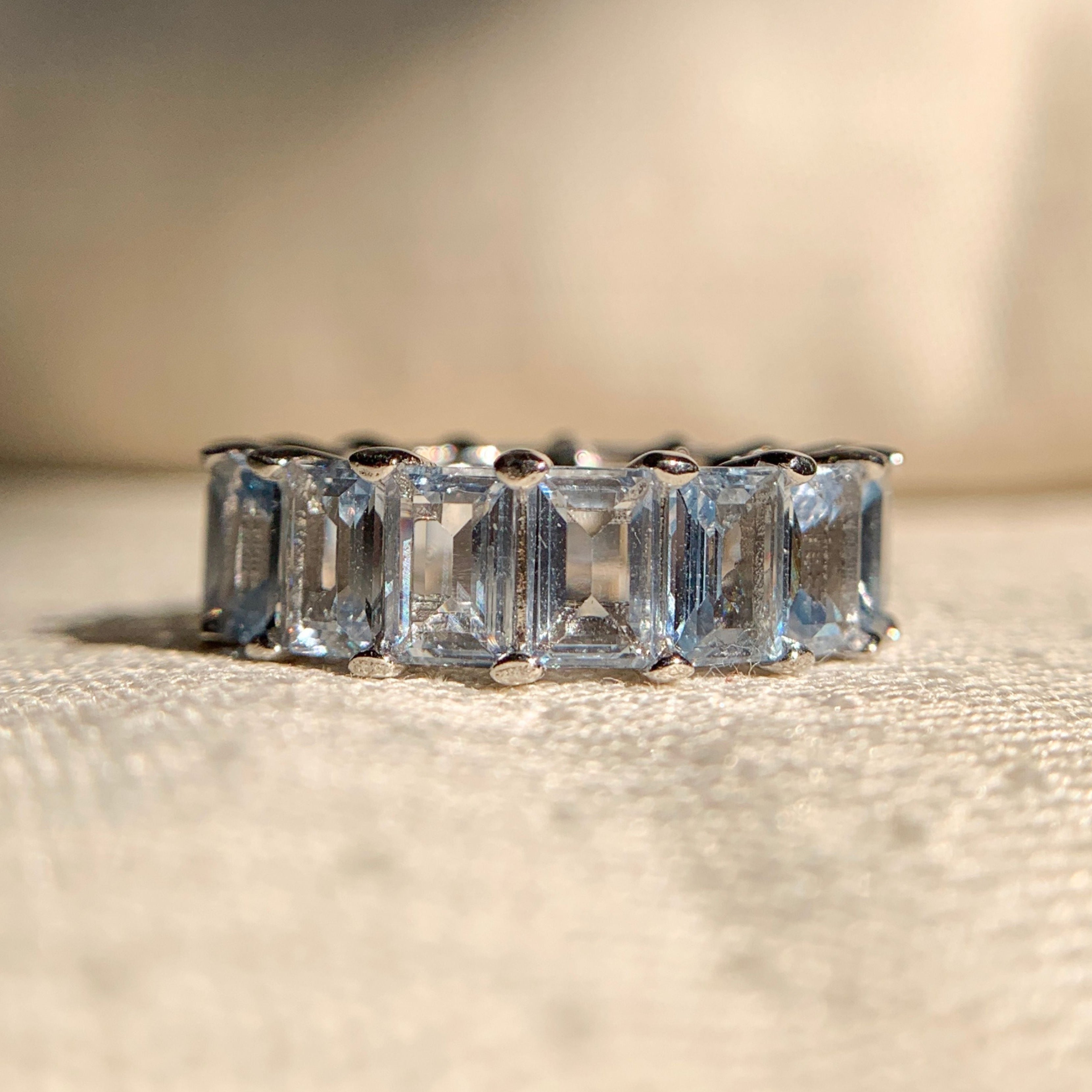 Aquamarine rose gold eternity band with continuous gemstone design